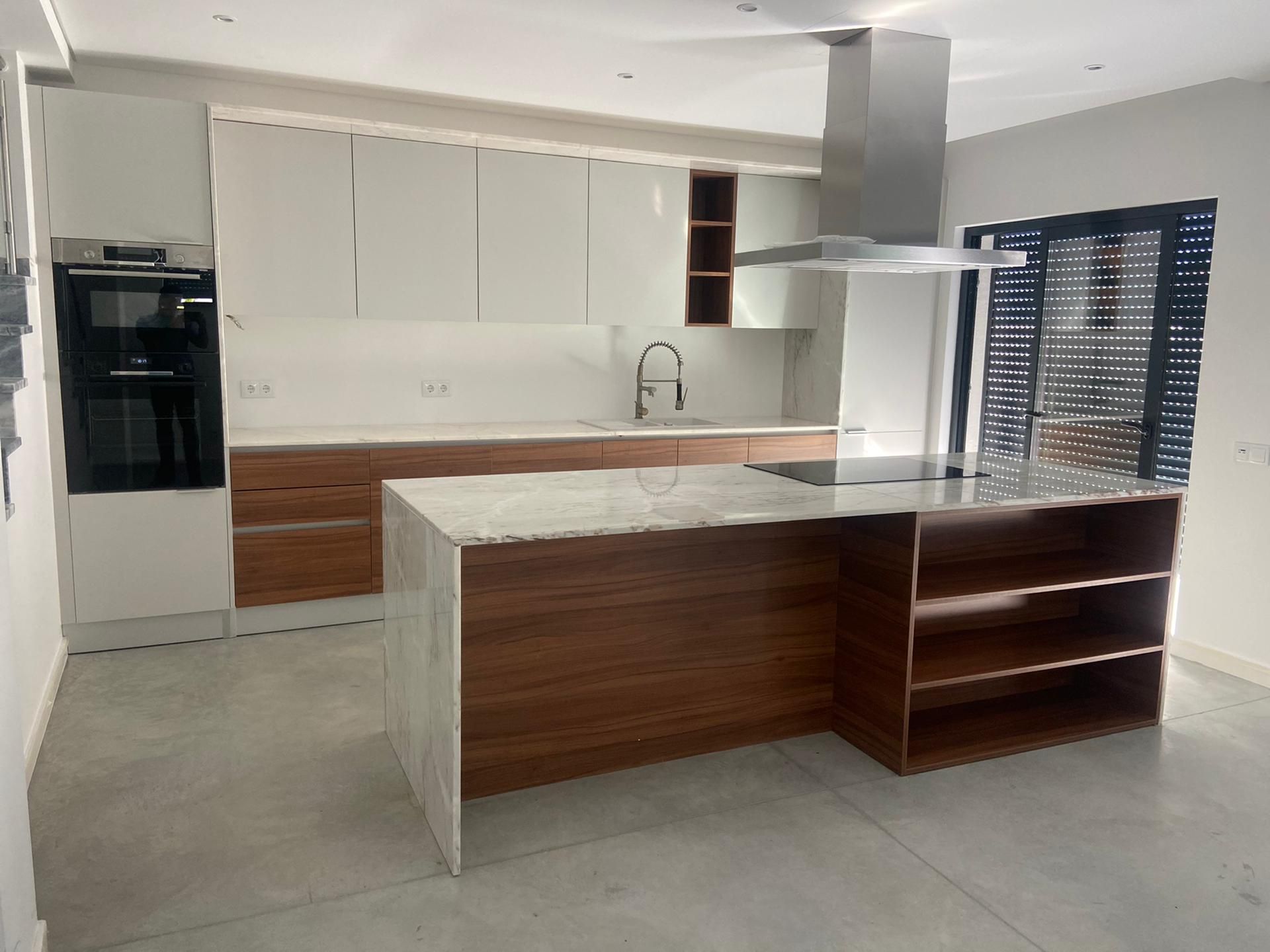 Bright kitchen with wood and stone island completed by RBWF in Fuseta
